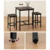 Three-piece high table set with stools and decor.